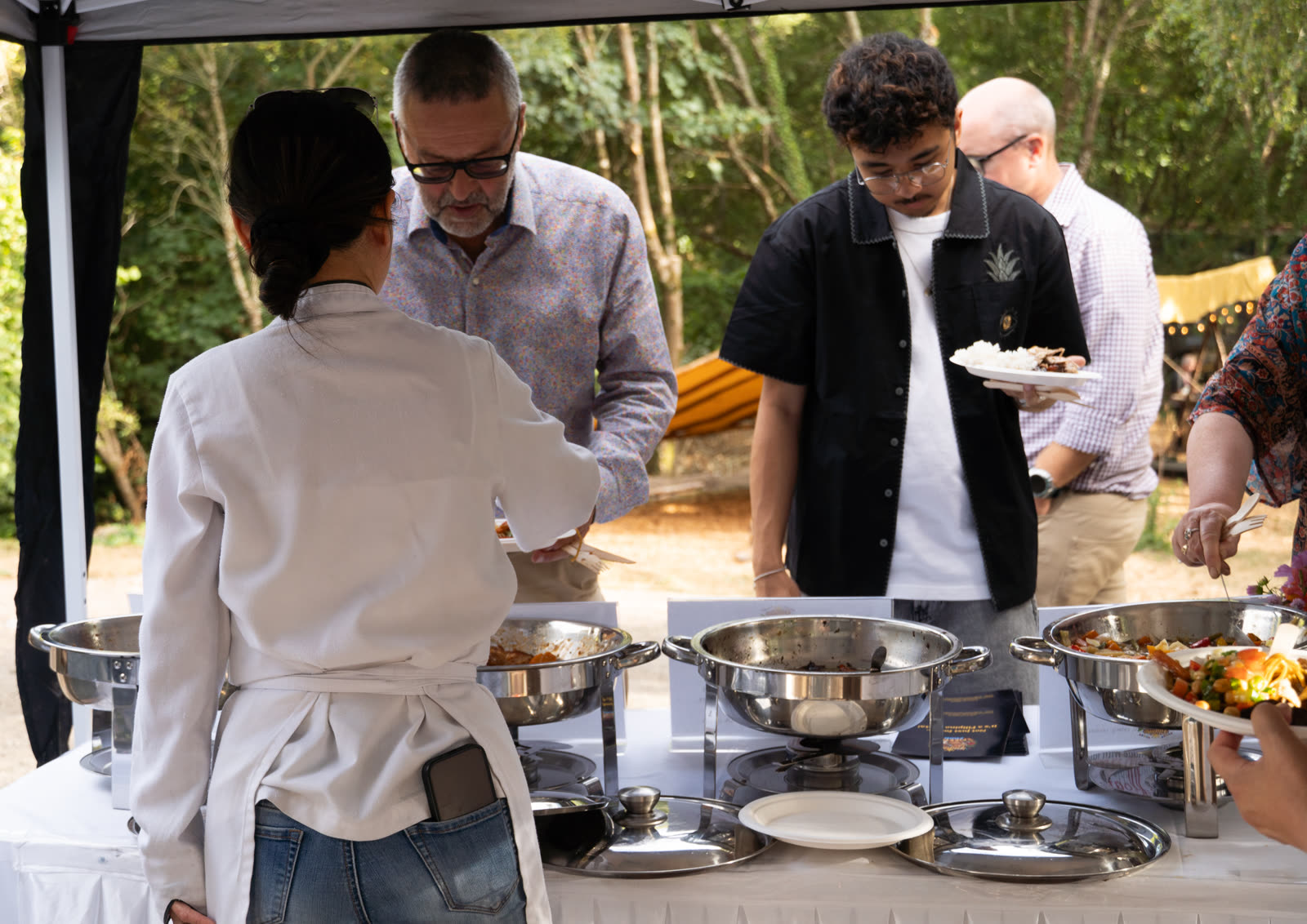 Filipino Fiesta Food buffet at an outdoor event with guests serving themselves