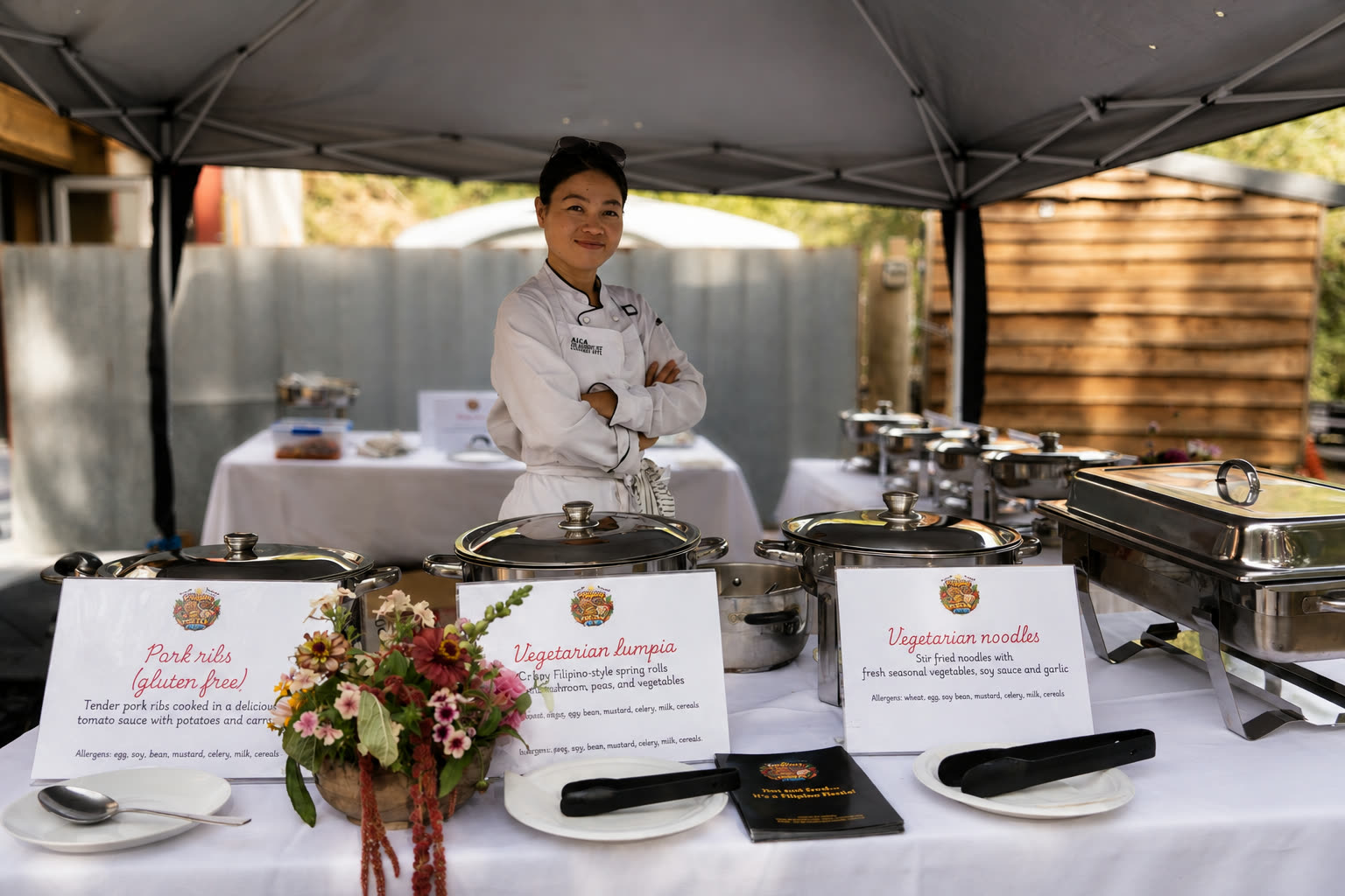 Filipino Fiesta Food chef standing behind a full buffet setup