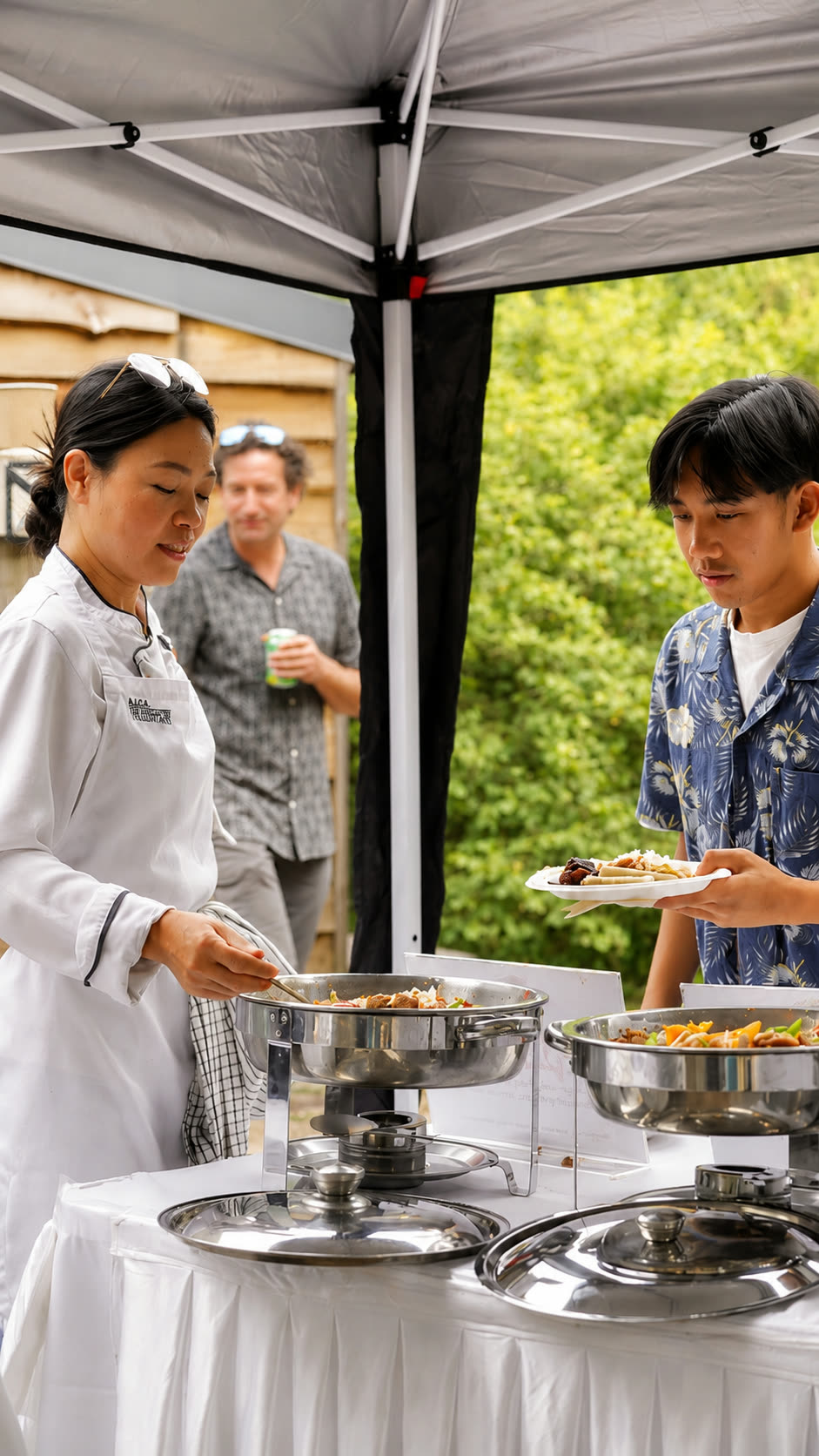 Chef serving a guest at a Filipino Fiesta Food catered event